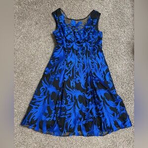 Aidan Mattox dress featuring black tulle overlay with vibrant blue embroidery.